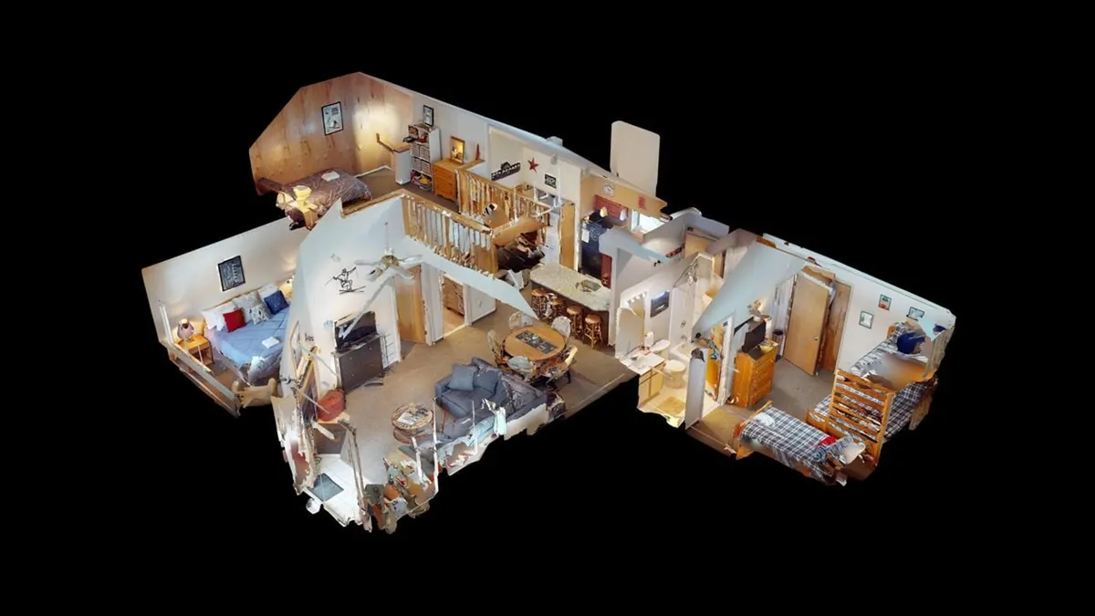 A homey open-concept space with a view of the dining table, kitchen, living area, and stairway, blending opportunities for gathering and socializing. The layout suggests a perfect base for group dinners and pre- or post-excursion relaxation.